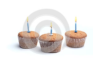Three cupcakes on a wooden table
