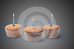 Three cupcakes on a wooden table