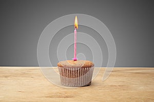 Three cupcakes on a wooden table