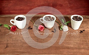 Three cups full of coffee beans with roses.