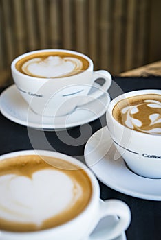 Three cups of hot cappucino coffees