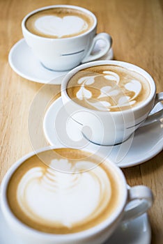 three cups of hot cappuccino coffees photo