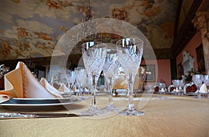 Three cut-glass gobles stand on dinner table