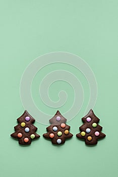 Three cute Christmas tree shaped cookies. Gingerbread cookies