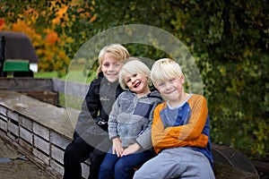 Three Cute Kids Bundled up Tractor Wagon Ride on Chilly Fall Day