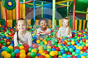 Three Cute Kids Playing in Ballpit