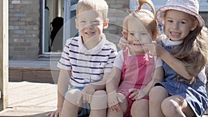 Three cute little Children enjoys delicious ice cream cone. Child eating watermelon popsicle. Kids Siblings snack sweets