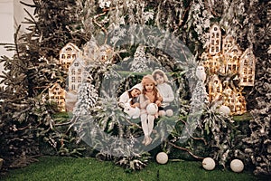 Three cute little girls in Christmas interior.