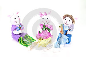 Three cute porcelain bunny rabbits ready for the Easter holiday, isolated on white background