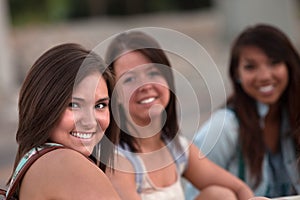 Three Cute Teen Girls Sitting