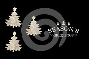 Three cutout Christmas trees on black background with Seasons`s greetings text photo