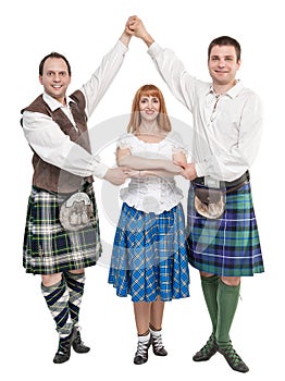 Three dancers in clothing for Scottish dance