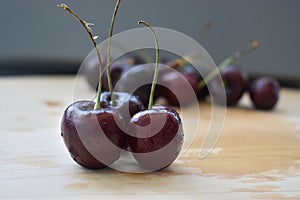 Three dark red cherries