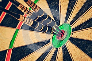 Three darts in bull's eye close up