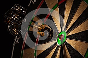 Three darts in bull's eye close up