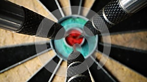 Three darts in the center of dartboard - set and achieve your aspirations and goals concept