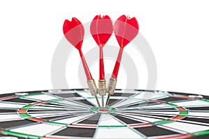 Three darts hit dead centre of target photo
