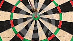 Three Darts Hitting Bullseye