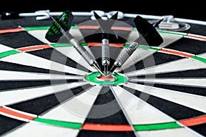 Three darts placed on a target.