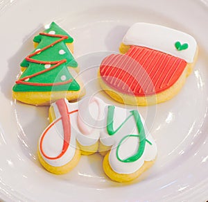 Three Decorated Christmas Sugar Cookies on a White Plate