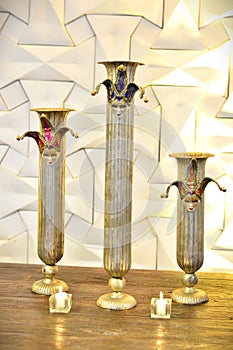 Three decorative vases with Venetian masks on the table at the party