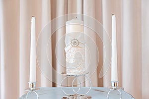 Three Decorative White Candles on Table