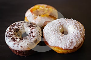 Three delicious Donuts on a black background
