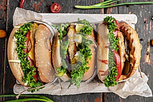 Three delicious homemade burgers of beef, cheese and vegetables, diet temptation resulting in unhealthy nutrition. top view