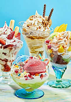 Three delicious ice cream sundaes on table