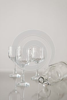 Three dessert wine glasses and empty bottle
