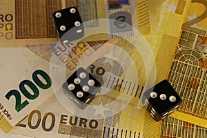 Three dice on 200 euro banknotes.