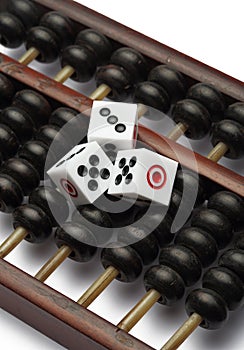 Three dice on abacus are symbolic of gambling