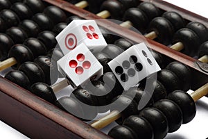 Three dice on abacus are symbolic of gambling