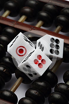 Three dice on abacus are symbolic of gambling