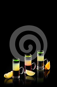 Three different alcoholic cocktails on a black background isolated