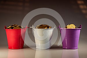 Three different buckets of coins photo