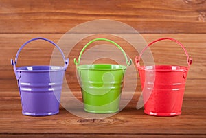 Three different colored buckets.