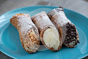 Three different delicious typical Sicilian cannoli filled with ricotta chse cream photo