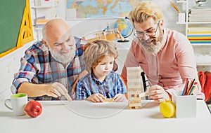 Three different generations ages: grandfather father and child son together. Happy man family have fun together