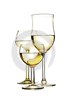 Three different glasses with white wine isolated on a white back