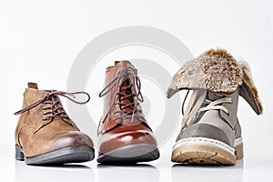 Three different leather womens boots on the white background isolated