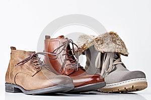Three different leather womens boots on the white background isolated