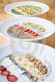 Three different Smoothie bowl with a selection of fruit granola, chia seed and coconut yogurt