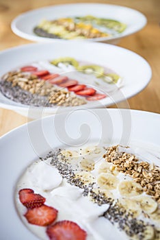 Three different Smoothie bowl with a selection of fruit granola, chia seed and coconut yogurt