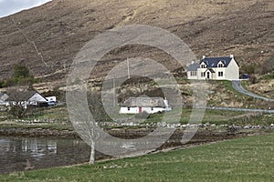 Three different type sof cottages by the side of a loch photo