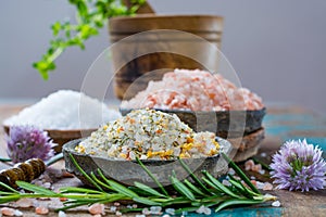 Three different types of natural salt in stone bowls on wooden s photo