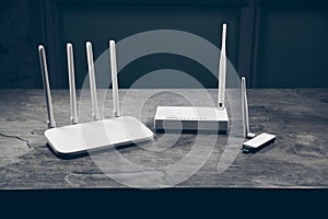 Three different types of Wi-Fi routers, modern and old technology. Wireless ethernet connection signal