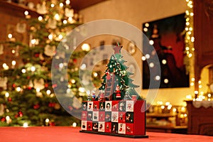 Three-dimensional Advent Calendar with stylised Christmas Tree in the middle of Christmassy decorated Family Room