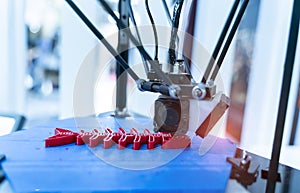 three dimensional 3D printer machine printing plastic model of fish skeleton