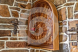 Three-dimensional icon on a Christian theme carved from wood photo
